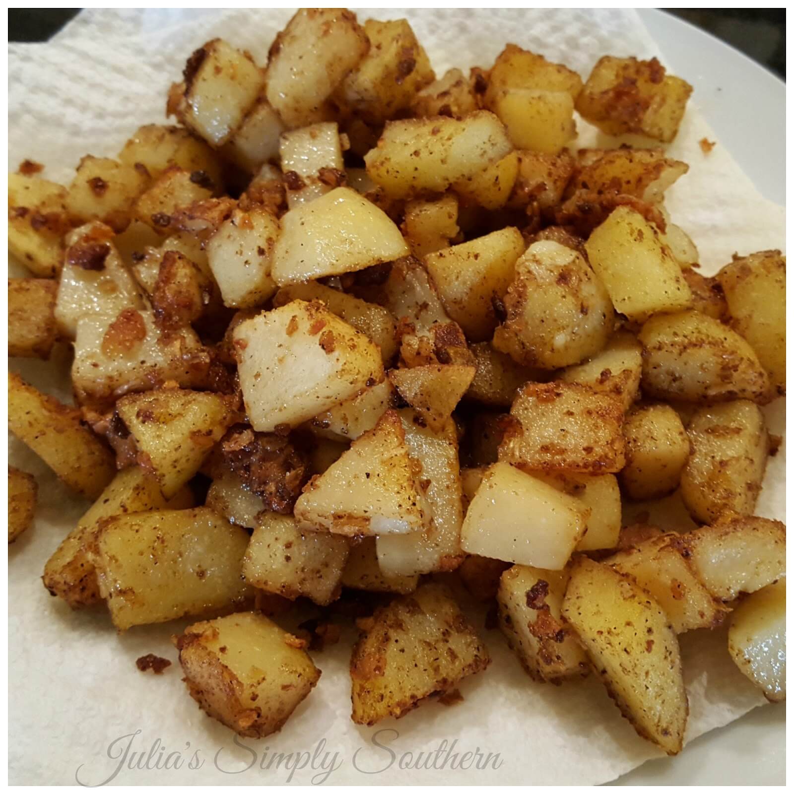 Southern Style Pan Fried Potatoes in a cast iron skillet - Julia's Simply Southern