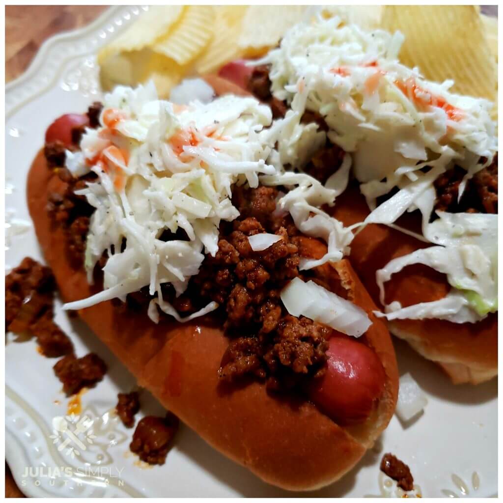 Hot Dog topped with coleslaw and served with potato chips