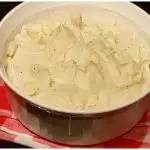 Best Southern Mashed Potatoes with Duke's Mayonnaise in a white bowl with gingham cloth