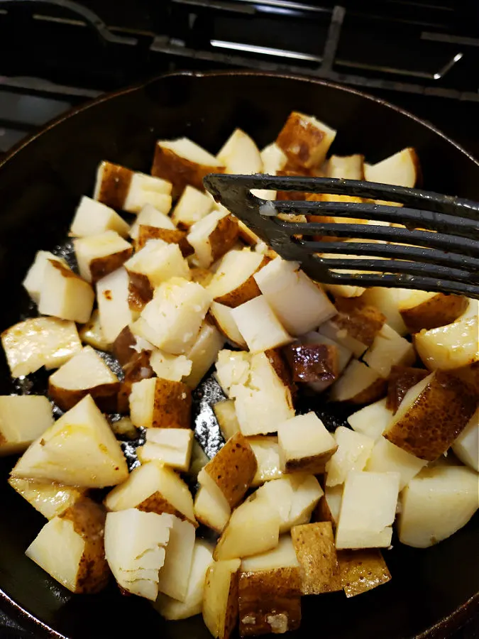 cooking potatoes in a skillet