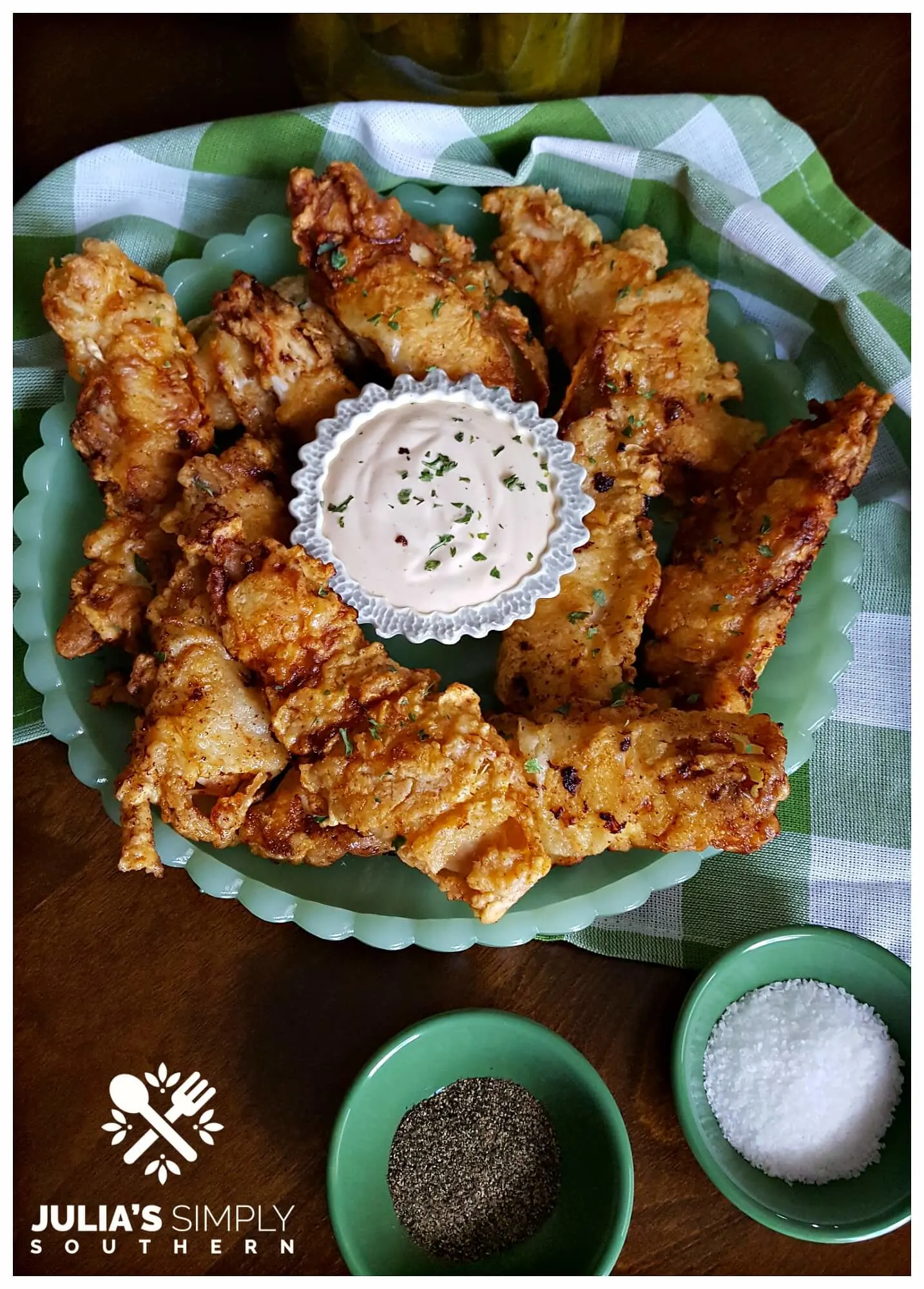 Delicious and flavorful dill pickle fried chicken breast tenders served on green jadeite glassware