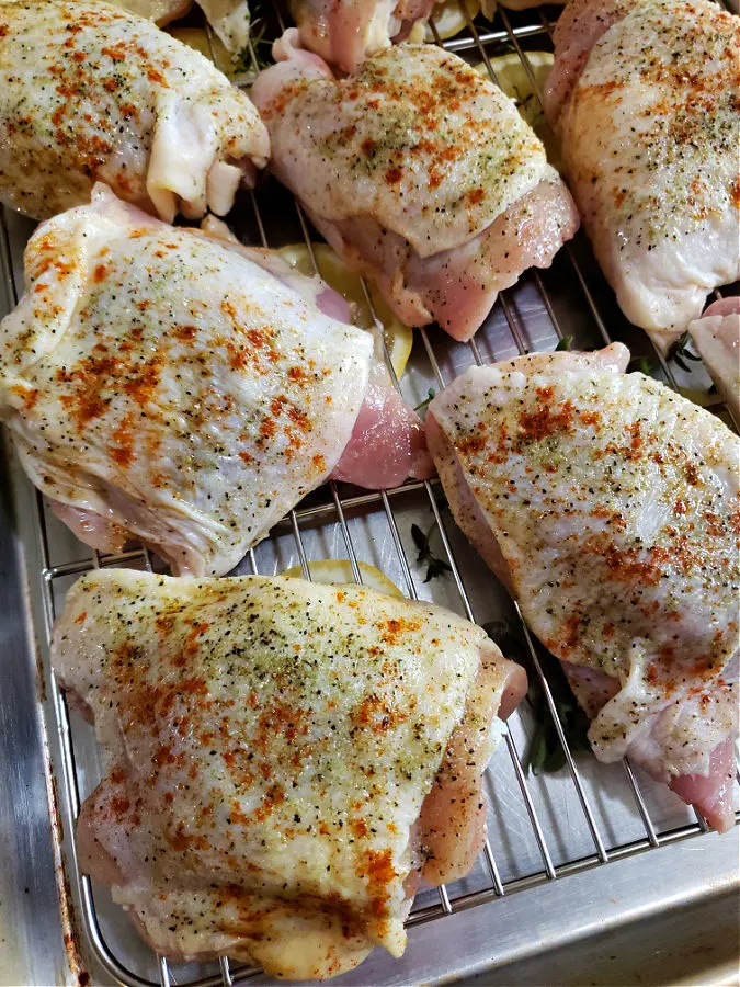 Season the skins of the bone-in chicken thighs before baking in a hot oven
