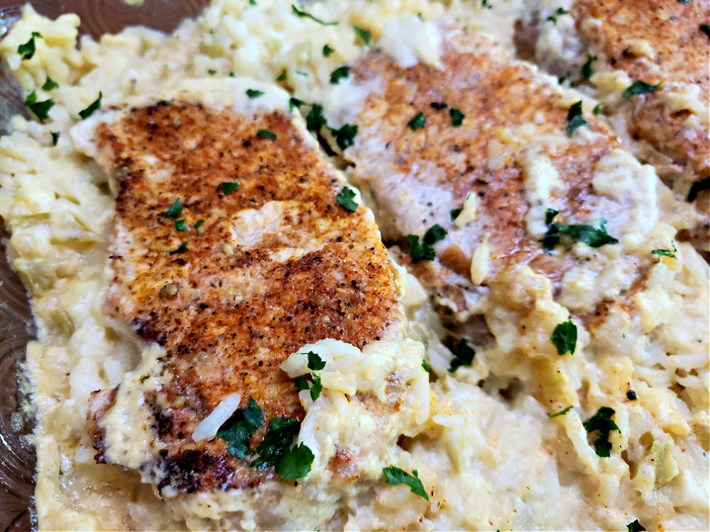 casserole dish with creamy rice and pork chops