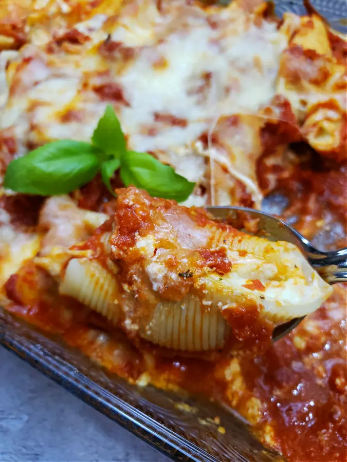 casserole pasta meal of stuffed jumbo shells filled with a creamy cheesy filling, topped with Rao's marinara and grated cheeses. Easy recipe with step by step instructions