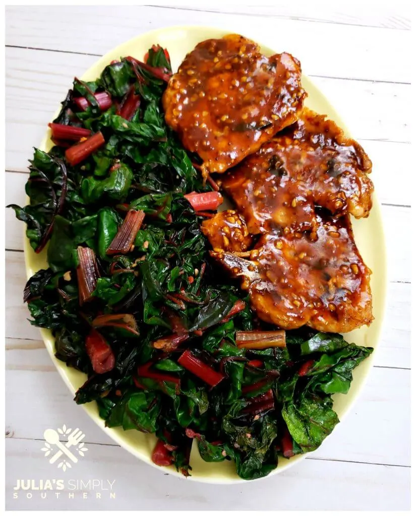 Healthy green vegetable recipe of Garlic Swiss Chard, shown on a platter - a highly nutritious vegetable
