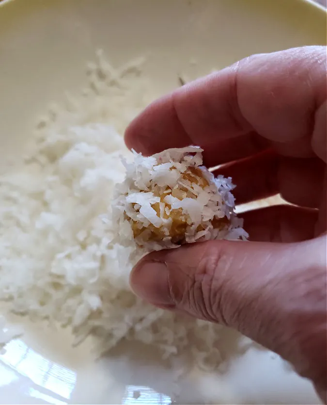 rolling dough in coconut