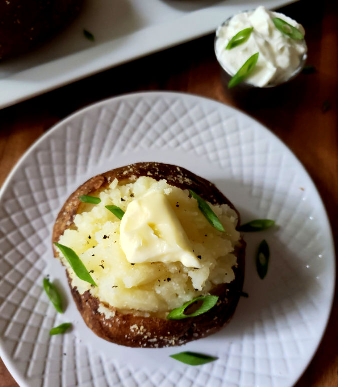 Best Air Fryer Baked Potato Recipe with toppings and garnished with spring onion slices