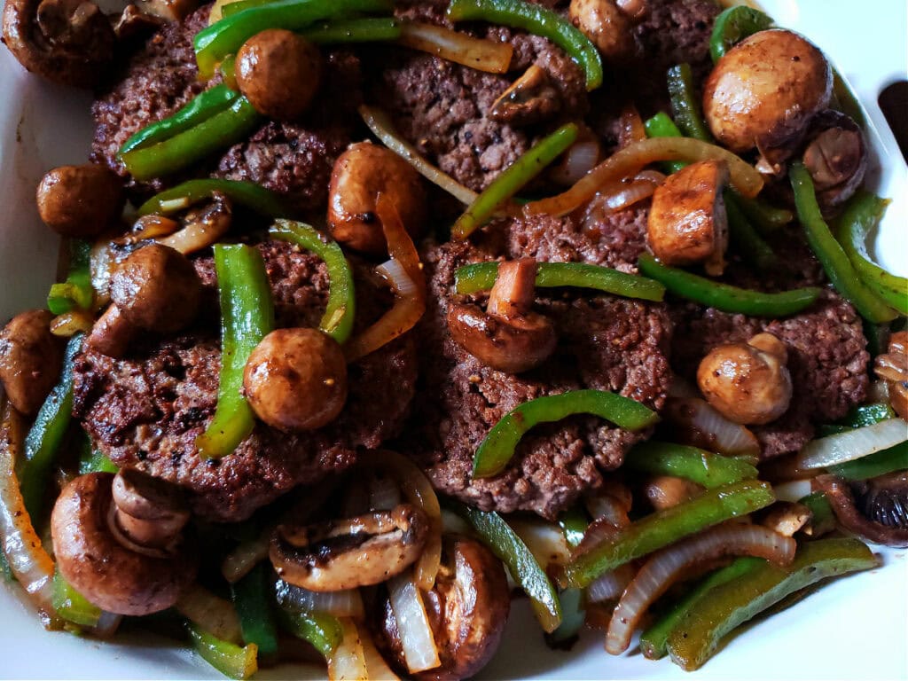 Hamburger Steak Recipe topped with sautéed onion, bell peppers and mushrooms - no gravy