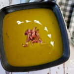 Split Pea Soup garnished with diced country ham and creamed hearts in a dark grey bowl