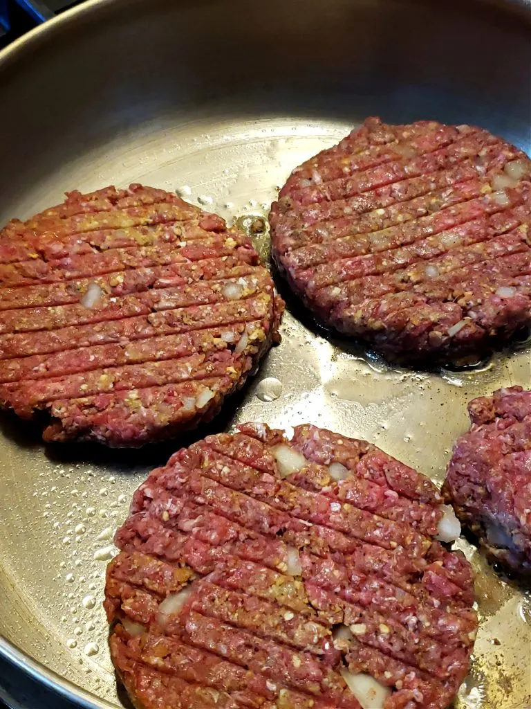 Salisbury steak patties in a skillet 