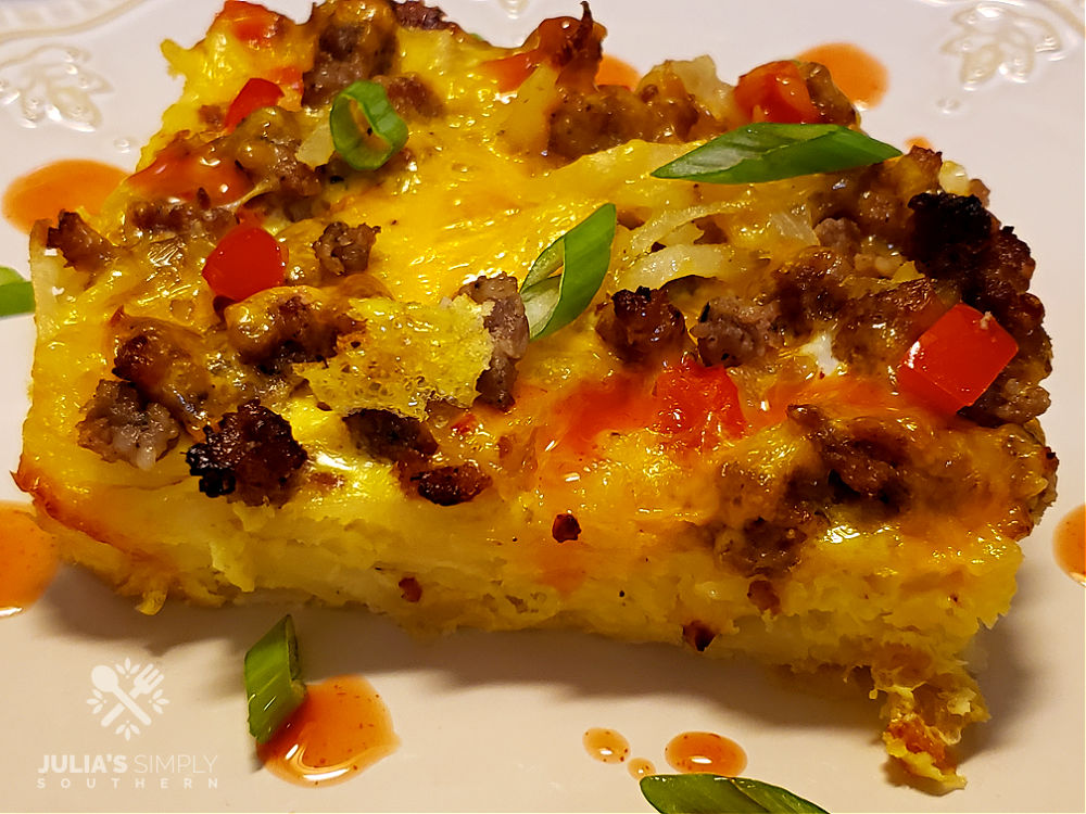 cheesy eggs, sausage and hash brown breakfast casserole on a plate