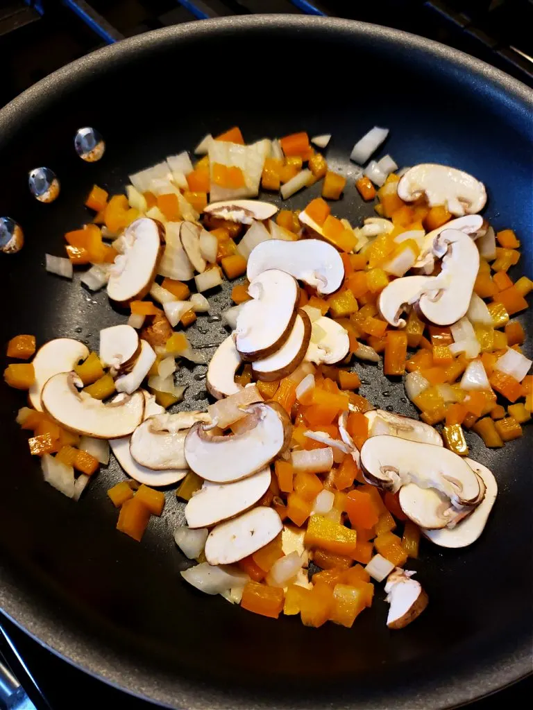 vegetables for crustless vegetable quiche recipe sautéing in a skillet