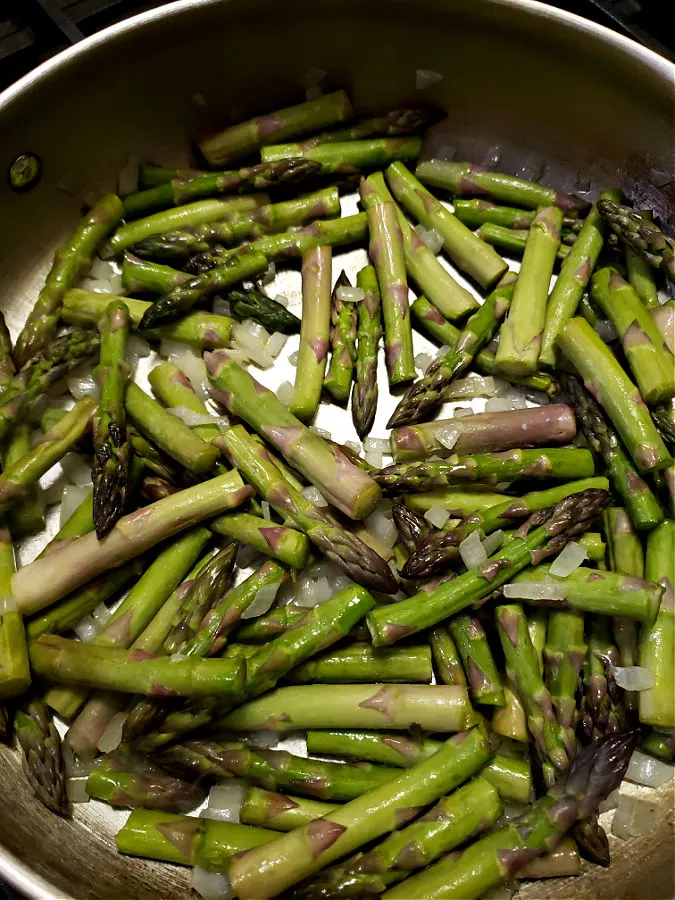 sautéing fresh asparagus with onion