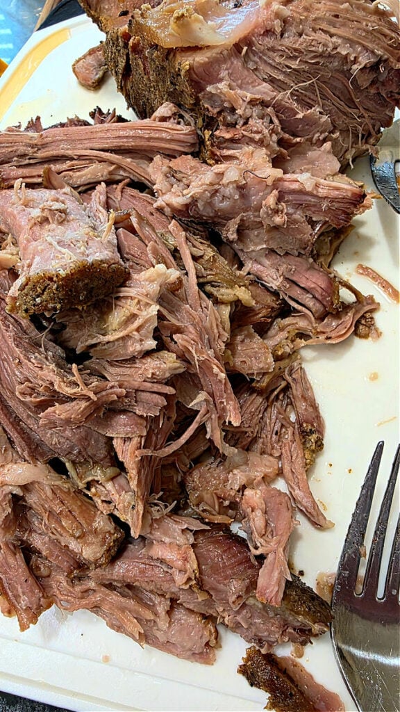 Shredding the tender pork roast meat