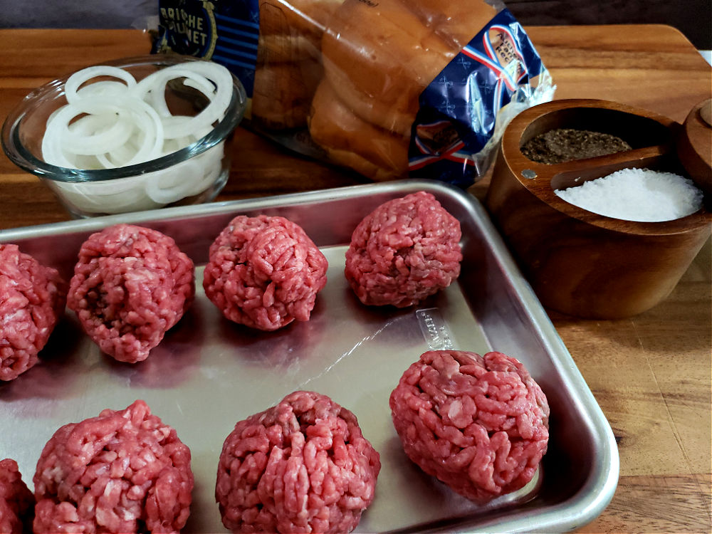 Ingredients on a cutting board to prepare smash burgers