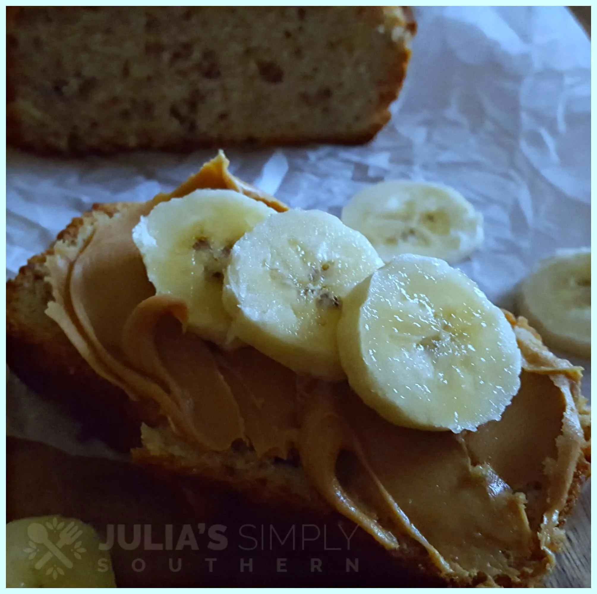 Delicious moist old fashioned homemade banana bread topped with peanut butter and sliced bananas