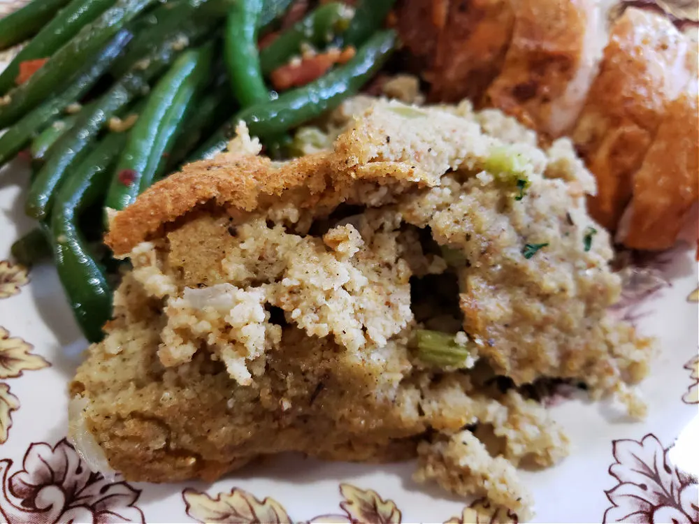 Plate of Southern holiday food with dressing, turkey and green beans