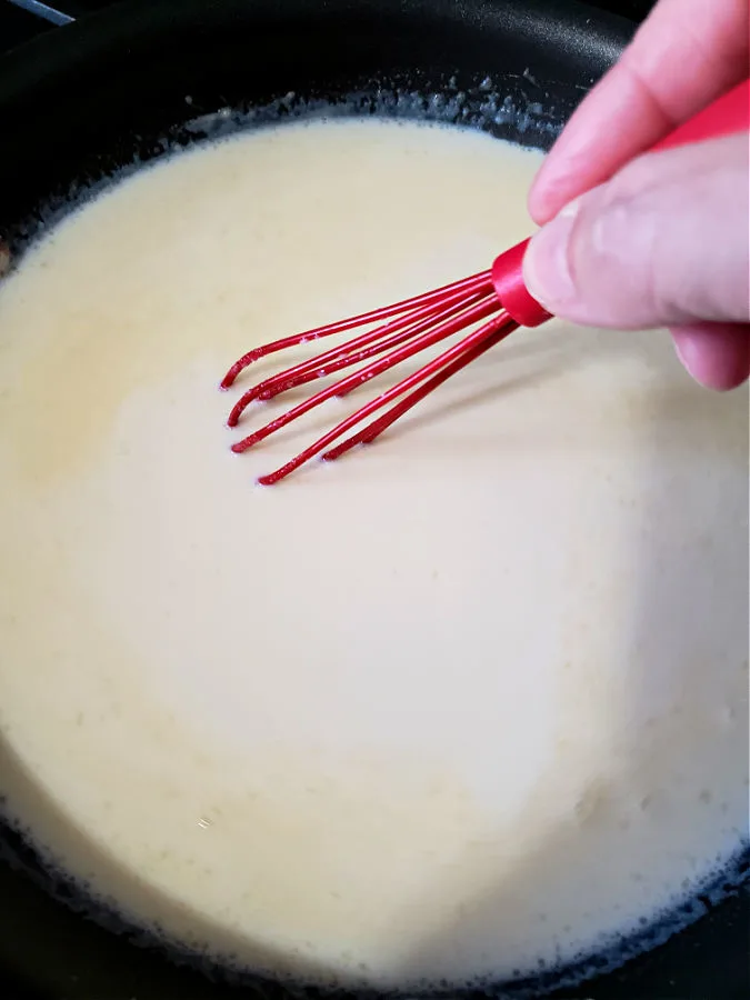 whisking mix into roux to make white gravy