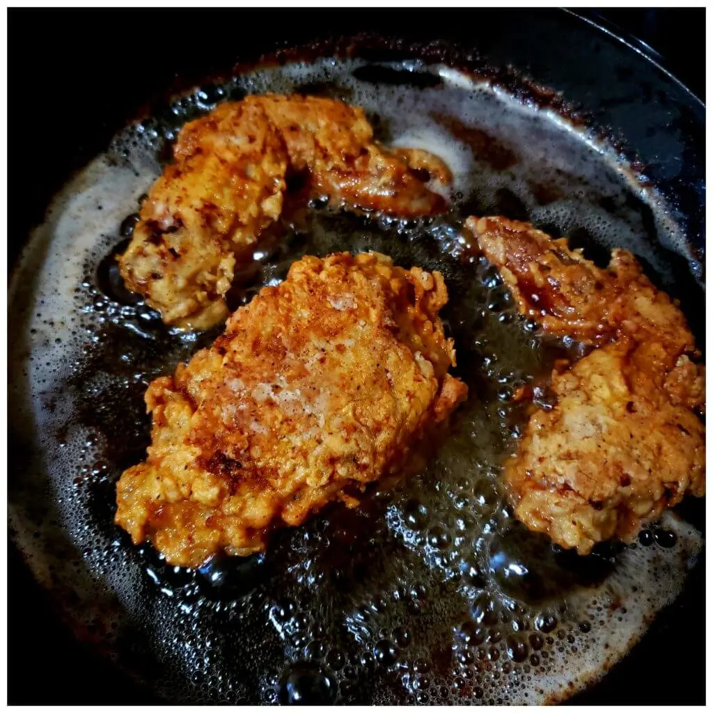 Crispy brown fried chicken in a skillet