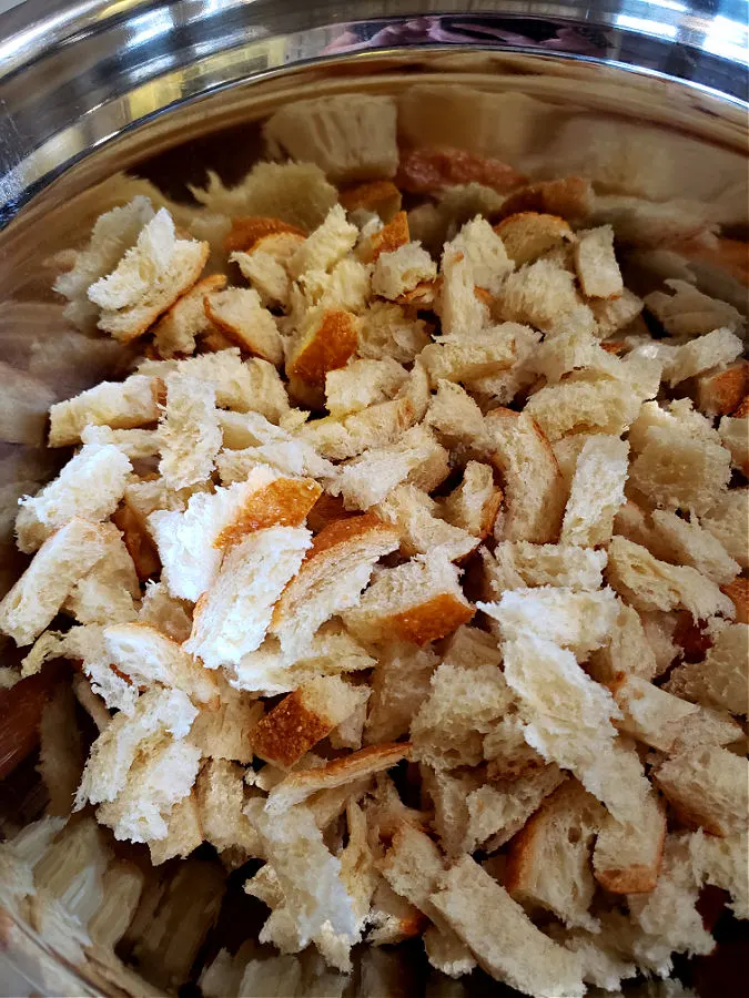 Sourdough bread cubes in a metal mixing bowl