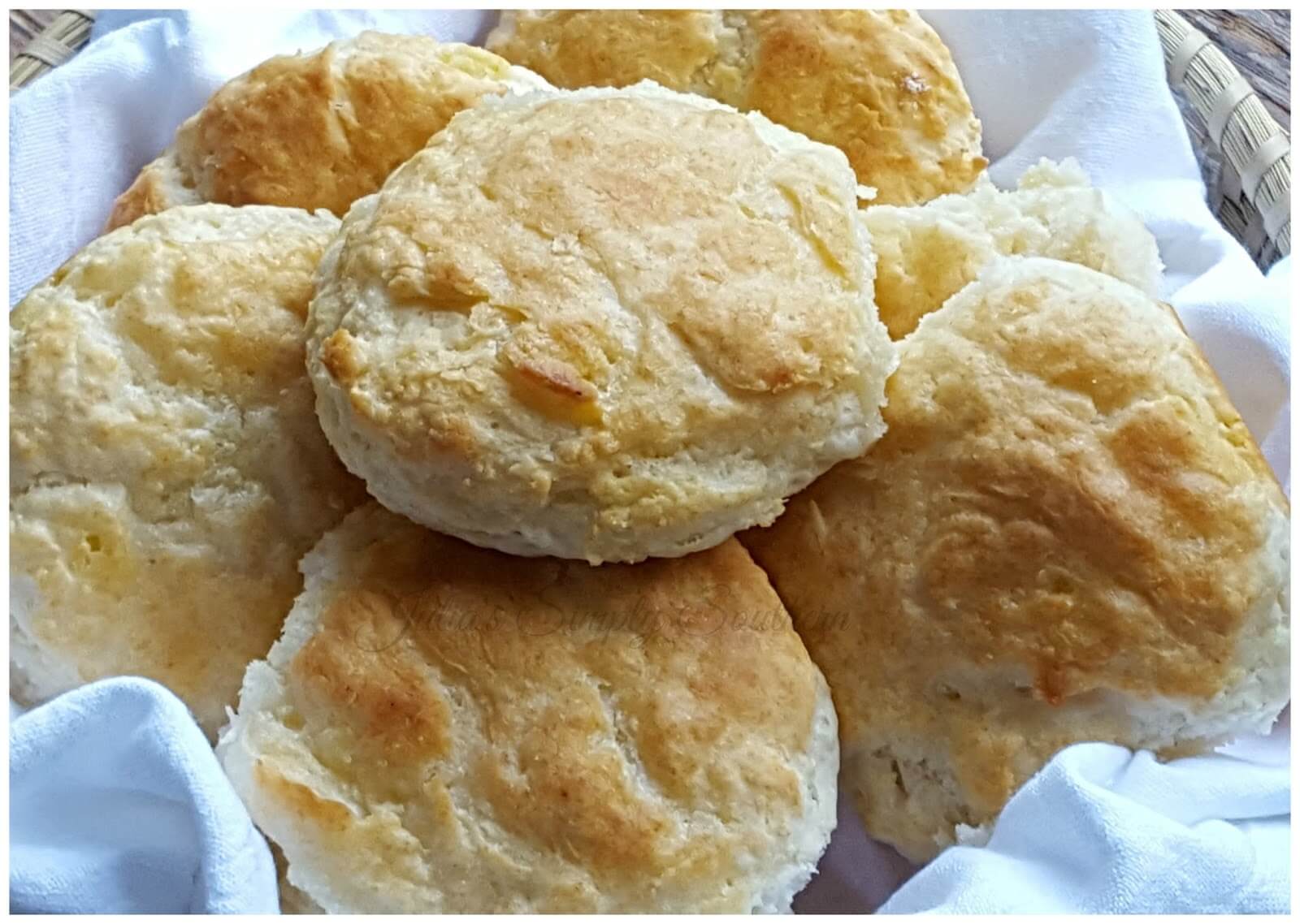 Homemade Southern Buttermilk Biscuits in a sweetgrass basket with cotton flour sack cloth