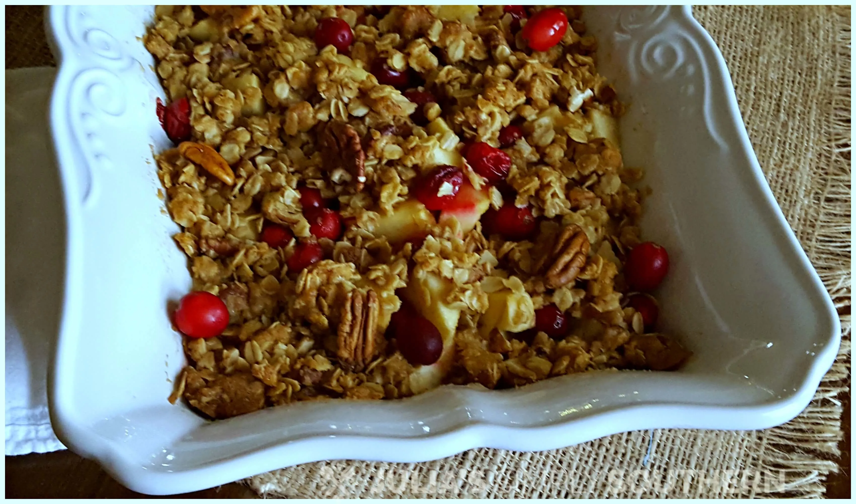 Southern Cranberry Apple Casserole dessert in a white baking dish. A delicious dessert for Christmas or a Southern new year dinner dessert