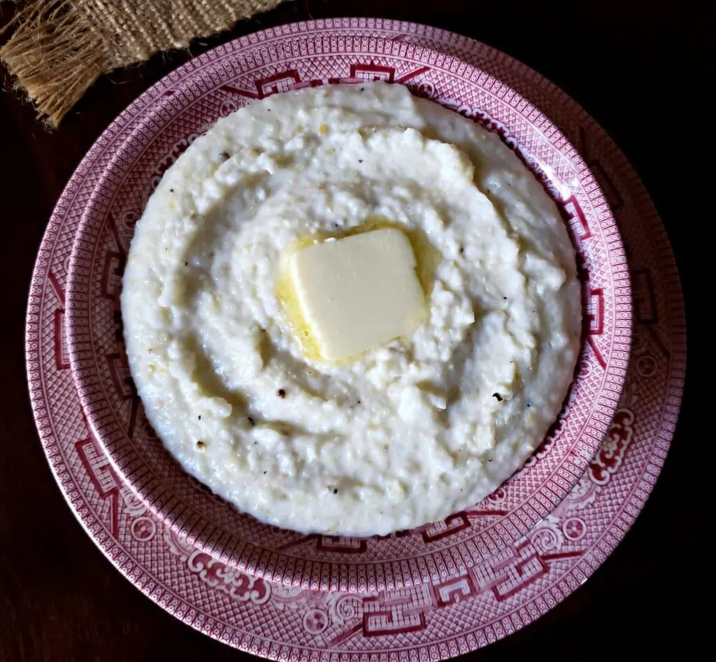 Thick creamy delicious grits in a serving bowl for breakfast