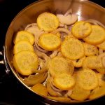 Skillet with yellow squash and onions