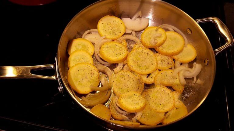 Skillet with yellow squash and onions