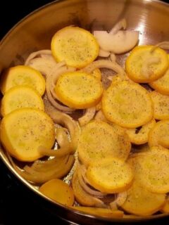 Skillet with yellow squash and onions
