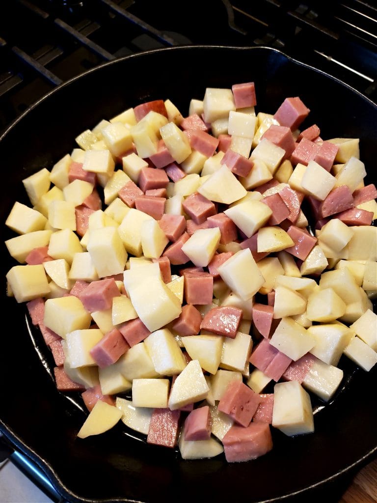 Spam and Potatoes frying in a skillet