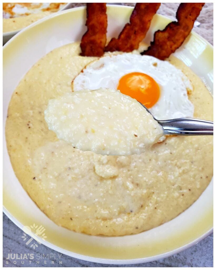 Recipe for how to make creamy cheese grits that are delicious served in a bowl with an egg and bacon