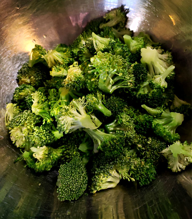 Steamed broccoli in a mixing bowl