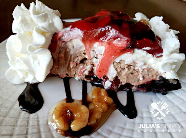 Amazing chocolate strawberry nut sundae pie dessert with a chocolate drizzle and candied nuts and whipped cream