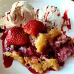 Fresh Strawberry Cobbler in a serving bowl with ice cream