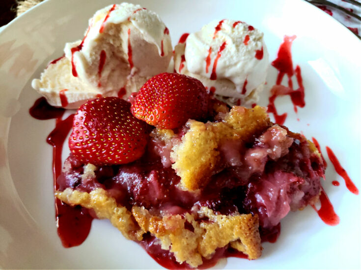 Fresh Strawberry Cobbler in a serving bowl with ice cream