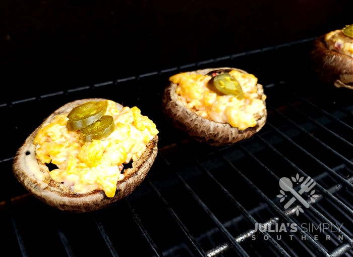 Gas grill cooking stuffed mushroom appetizer