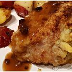 Stuffed Pork Chop on a plate with red potatoes