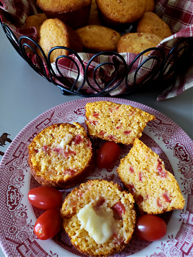 plate with  corn muffins with a basket of cornbread muffins
