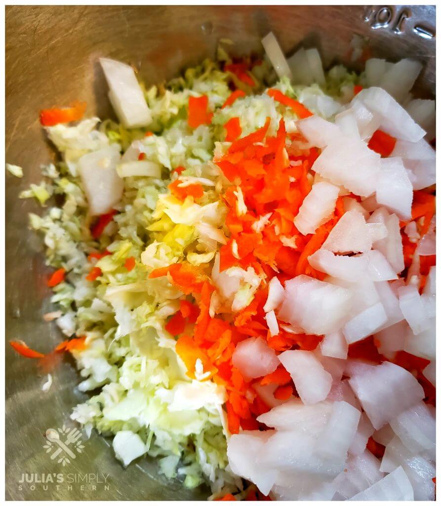 Vegetables for coleslaw in a mixing bowl