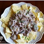 Best beef stroganoff recipe with buttered noodles on a cream plate