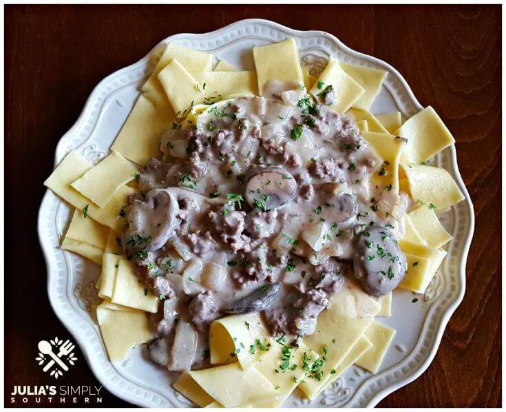 Best beef stroganoff recipe with buttered noodles on a cream plate