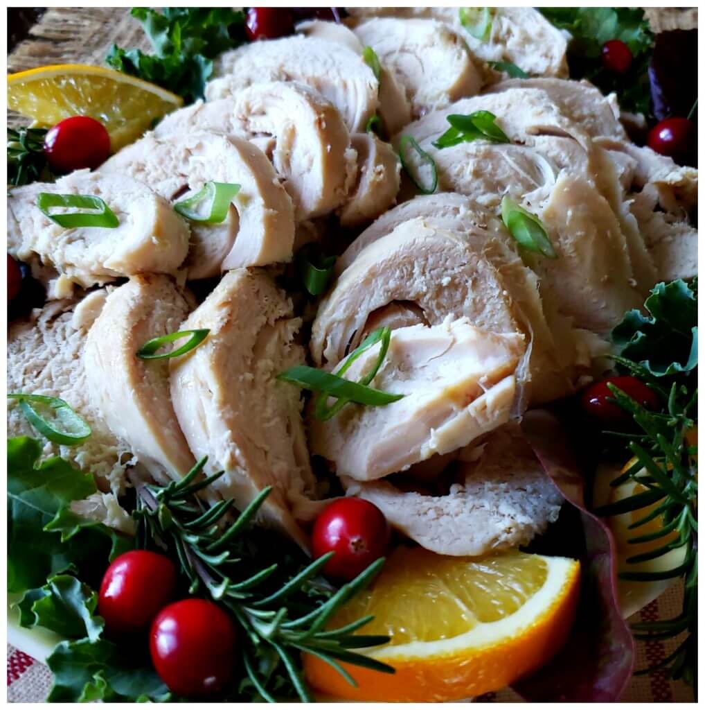 Slow cooker turkey breast sliced on a platter with holiday garnishment - Crock Pot Turkey Breast Recipe