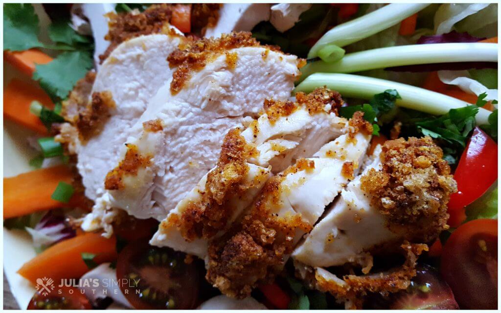 Delicious air fried chicken on a garden salad