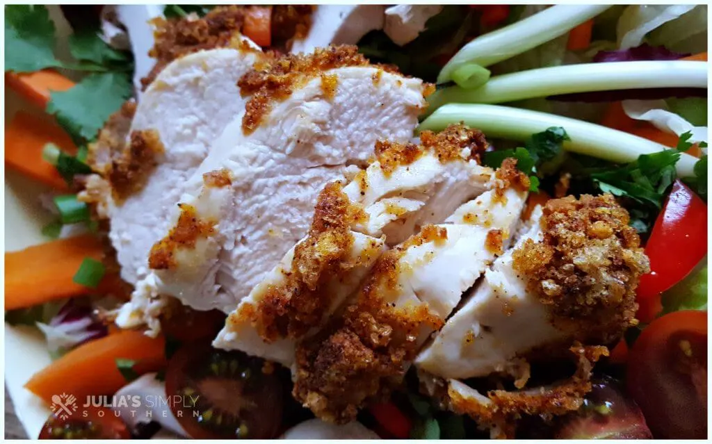 Delicious air fried chicken on a garden salad