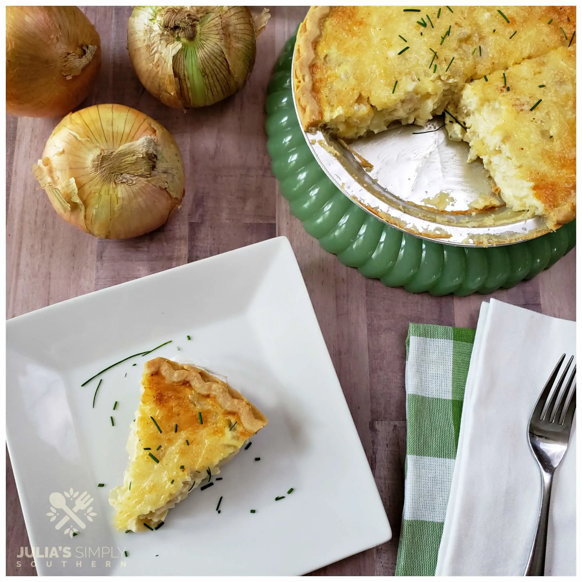 Green jadeite stand with an onion pie sitting on it next to three Vidalia onions 