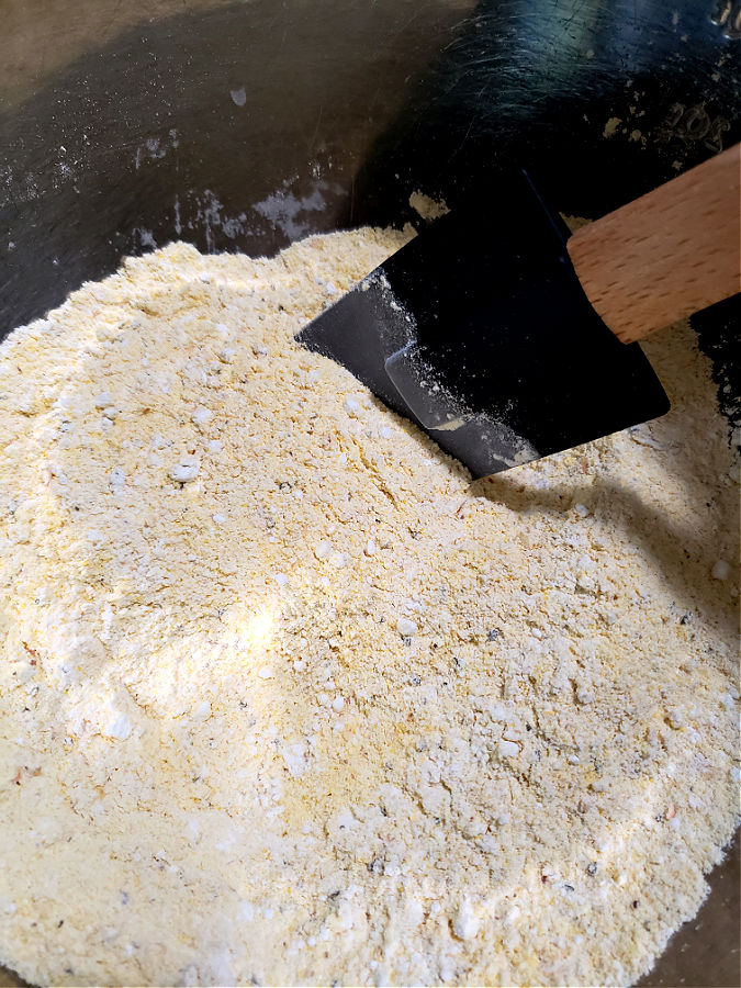 Dry ingredients in a mixing bowl - cornmeal and flour