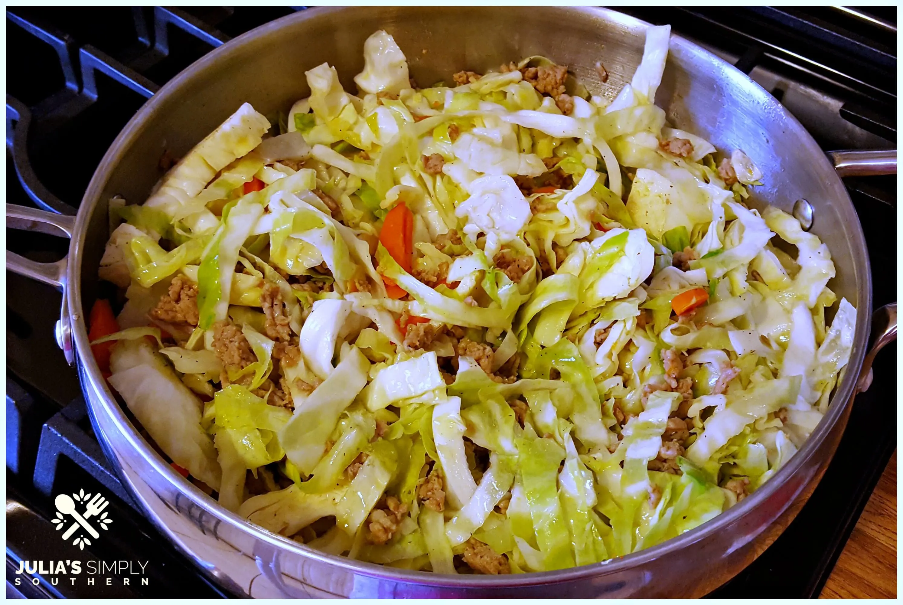 Stir Fry - Egg roll in a bowl - pork, cabbage and carrots in a silver skillet