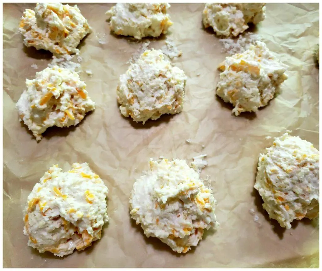 Lined baking sheet with drop biscuit dough ready for the oven