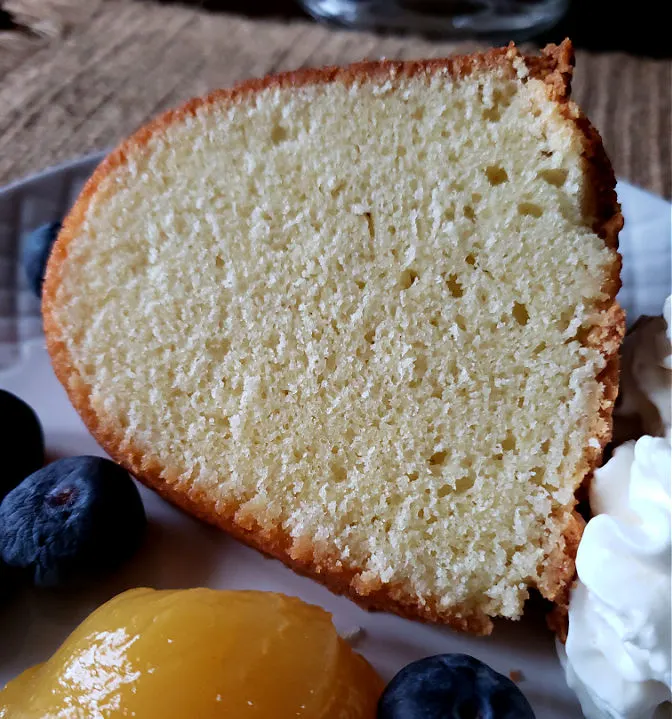 Moist pound cake slice with berries and lemon curd - baking from scratch